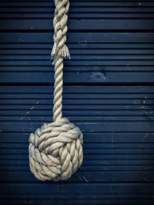 Nautical knot on a blue wooden background
